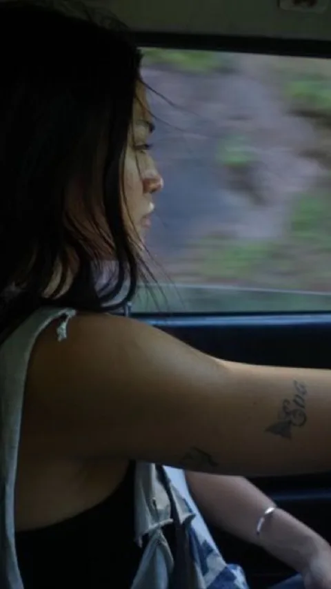 A woman looking out of a car window in daylight. Sample hook: no rush to get where you used to be